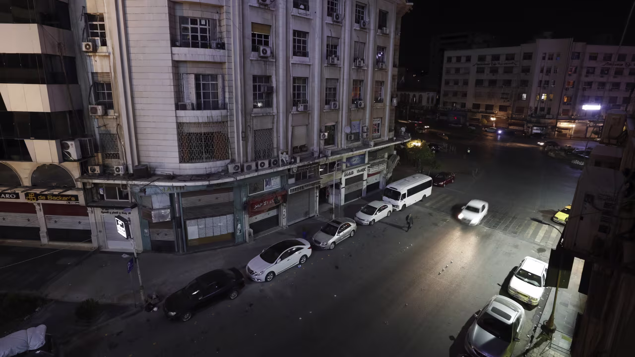A person drives on a deserted street in Damascus, Syria, on December 7.