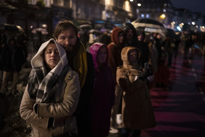 Spectators gather outside the cathedral on Saturday.