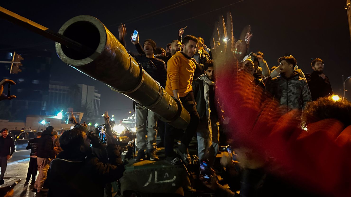 Syrians celebrate the arrival of opposition fighters in Damascus, Syria, on December 8, 2024.