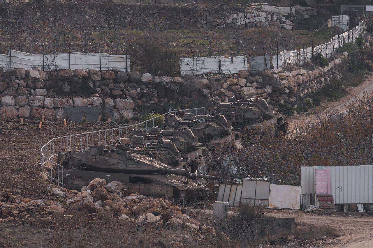 Israeli armored vehicles park near the Alpha Line that separates the Israeli-annexed Golan Heights from Syria, on December 8, 2024.