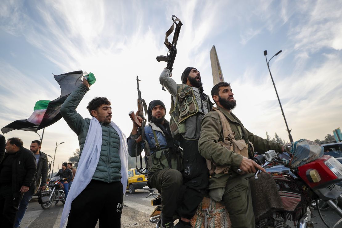 Syrian opposition fighters in Damascus celebrate after the Syrian government collapsed on December 8, 2024.