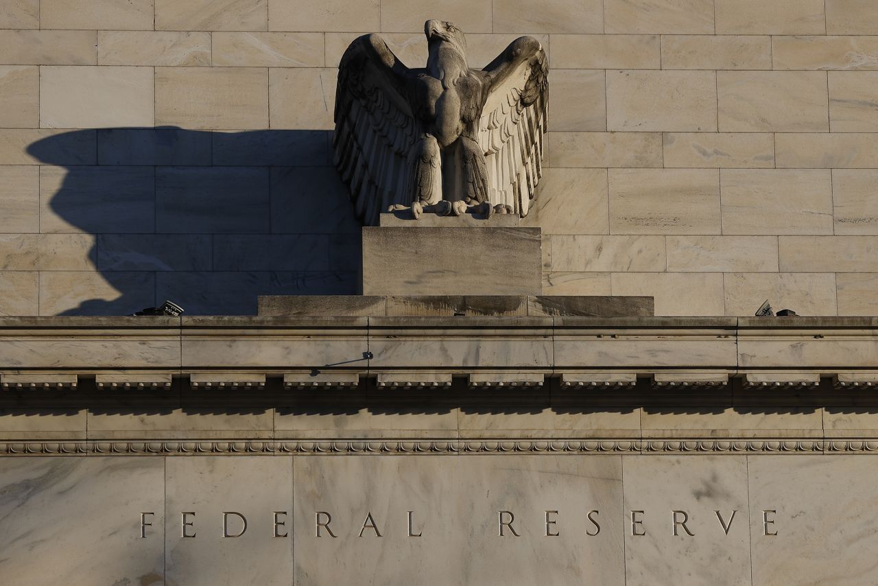 The Fed holds interest rates steady but cuts economic growth forecasts ...