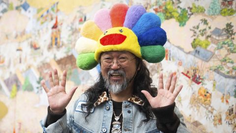 Artist Takashi Murakami poses in front his work named Gion Sairei-zu during a photo call ahead of his new exhibition, Japanese Art History a la Takashi Murakami, at Gagosian Grosvenor Hill, central London. Picture date: Tuesday December 10, 2024. 78444340 (Press Association via AP Images)