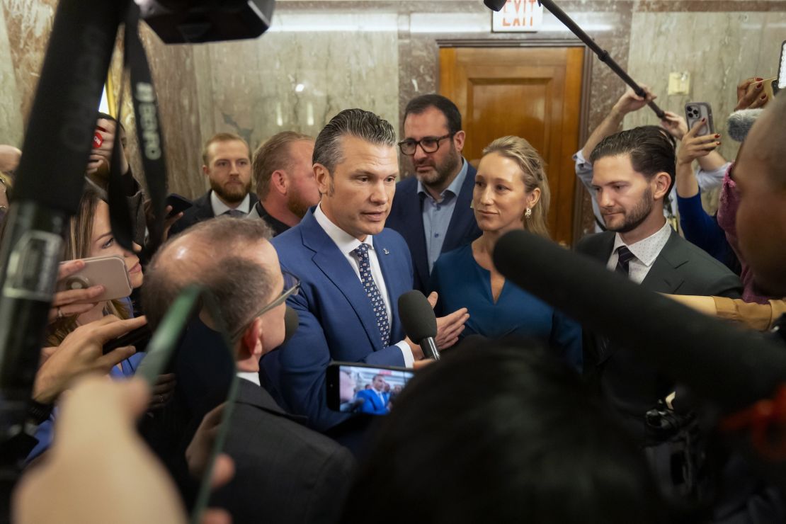 Pete Hegseth, President-elect Donald Trump's choice to be defense secretary, is joined by his wife Jennifer Rauchet as he speaks with reporters after meeting with Sen. Susan Collins, R-Maine, on Capitol Hill, Wednesday, Dec. 11, 2024, in Washington. (AP Photo/Mark Schiefelbein)