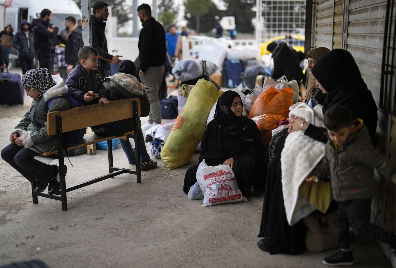 Syrians wait to cross into Syria from Turkey at the Oncupinar border gate.