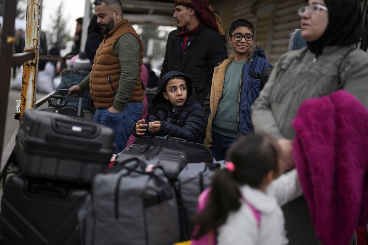 Syrians wait to cross into Syria from Turkey at the Oncupinar border gate, near the town of Kilis in southern Turkey, on December 12.