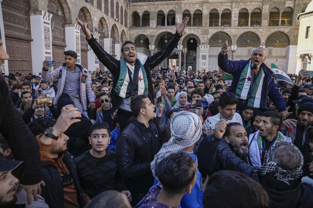 Syrians chant slogans as they gather for Friday prayers at the Umayyad mosque in Damascus, on December 13.