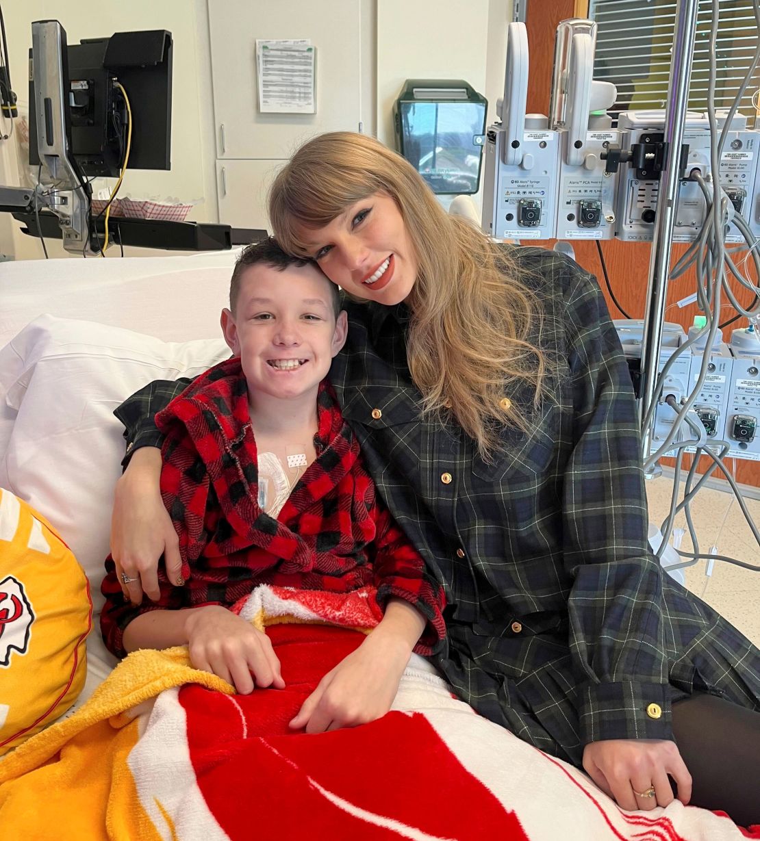 (From left) Children's Mercy Hospital patient Beckett Thomas and Taylor Swift -- wearing the same outfit she gifted Naya Jade (not pictured) -- at Children's Mercy Hospital in Kansas City on December 12.