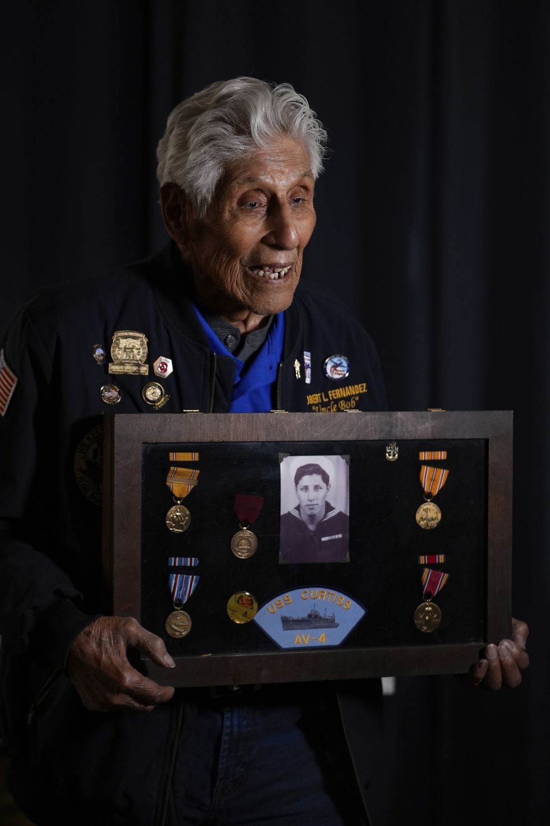 Pearl Harbor Navy veteran Bob Fernandez poses for a photograph with medals from his military service, Tuesday, Nov. 19, 2024, in Lodi, Calif.