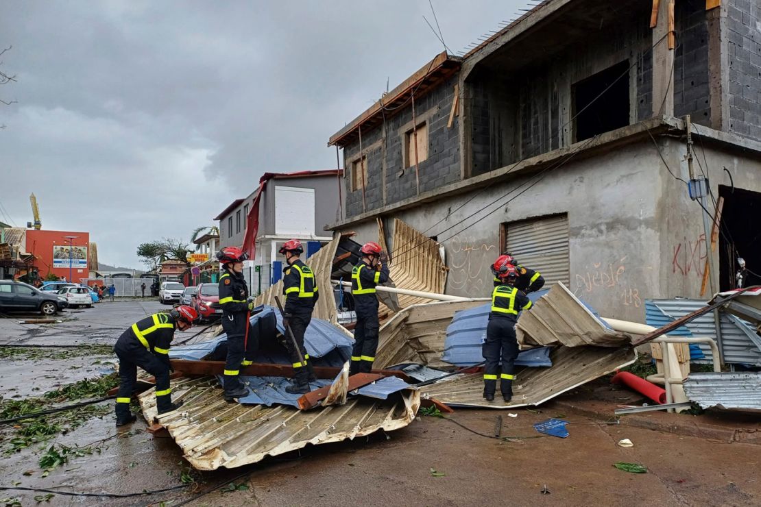 This photo provided Sunday December 15, 2024 by the Civil Security shows rescue workers clearing an area in the French territory of Mayotte in the Indian Ocean, after Cyclone Chido caused extensive damage.