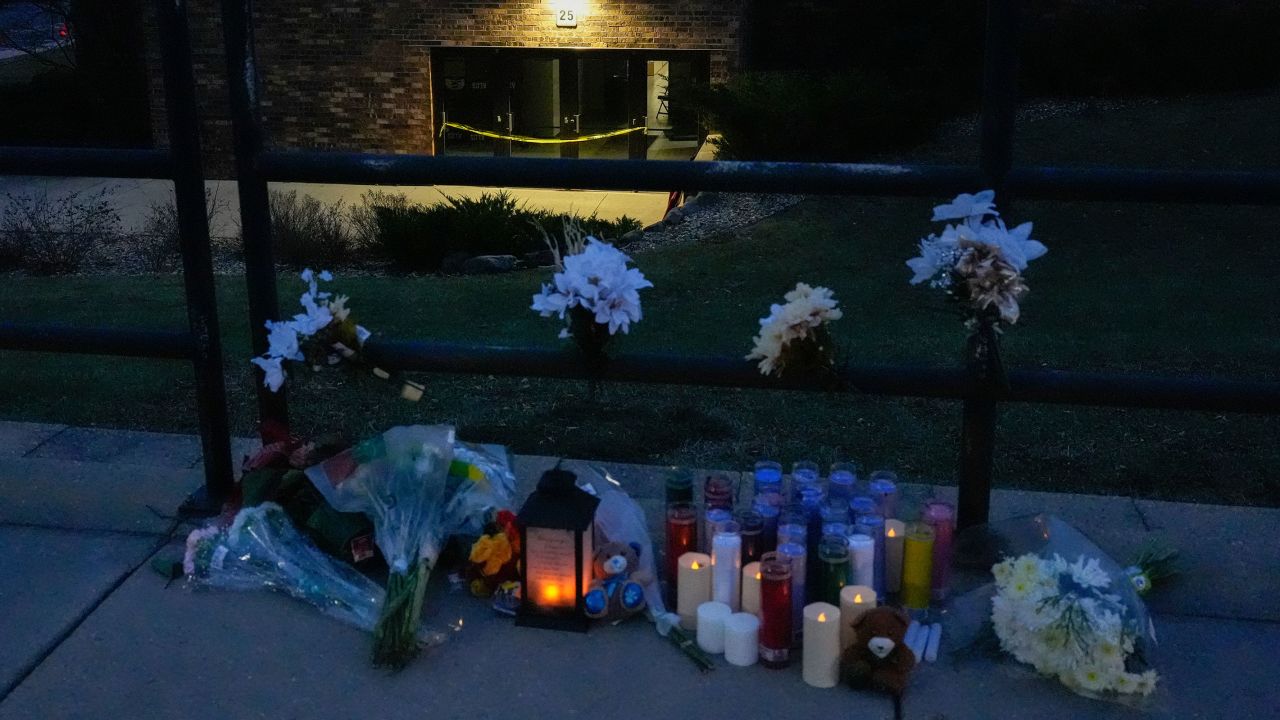 Flowers and candles are placed outside the Abundant Life Christian School Tuesday, Dec. 17, 2024 in Madison, Wis., following a shooting on Monday. (AP Photo/Nam Y. Huh)