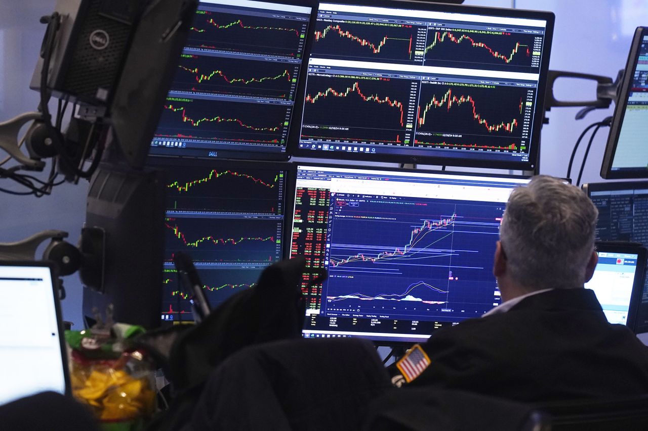 A trader studies his screens as he works on the floor of the New York Stock Exchange on Wednesday, December 18.