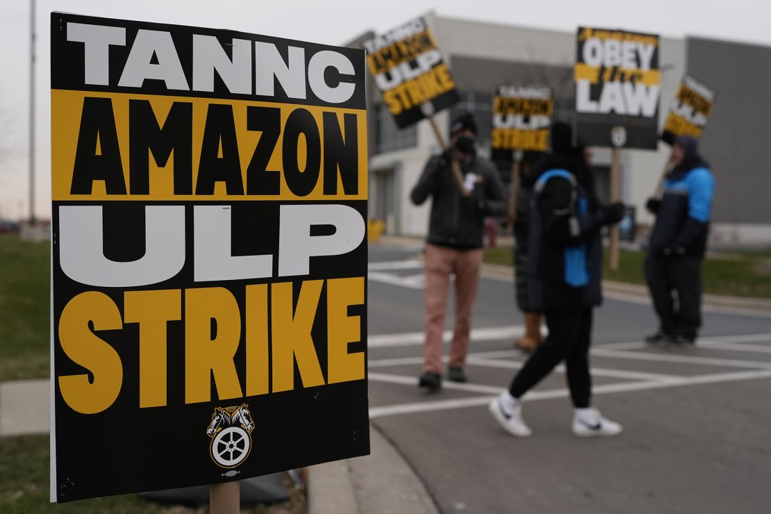 Strikers hold signs during a strike at Skokie (DIL7) Amazon Delivery station in Skokie, Illinois, on December 19.