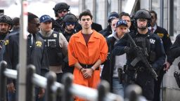 Luigi Mangione, a suspect in the fatal shooting of UnitedHealthcare CEO Brian Thompson, is escorted by police, Thursday, Dec. 19, 2024, in New York. (AP Photo/Pamela Smith)