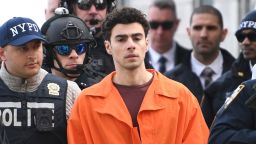 Luigi Mangione, the suspect in the fatal shooting of UnitedHealthcare CEO Brian Thompson, is escorted by police, Thursday, December 19, in New York.