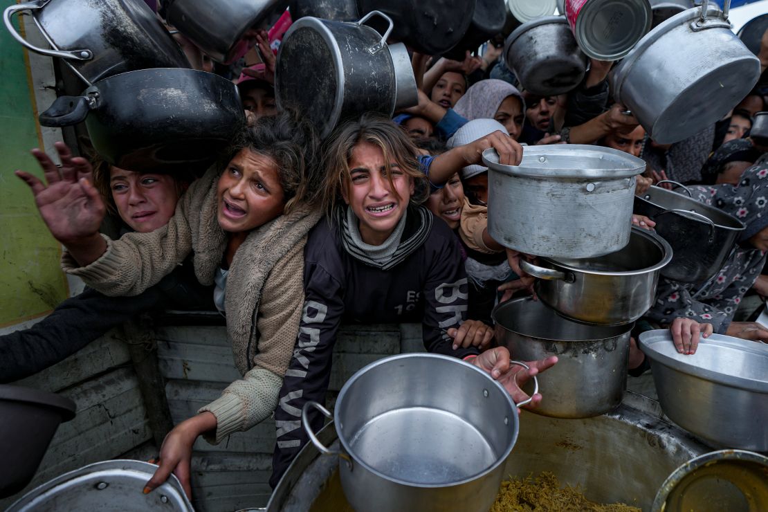 Palestinians struggle to get food at a distribution center in Khan Yunis, southern Gaza.