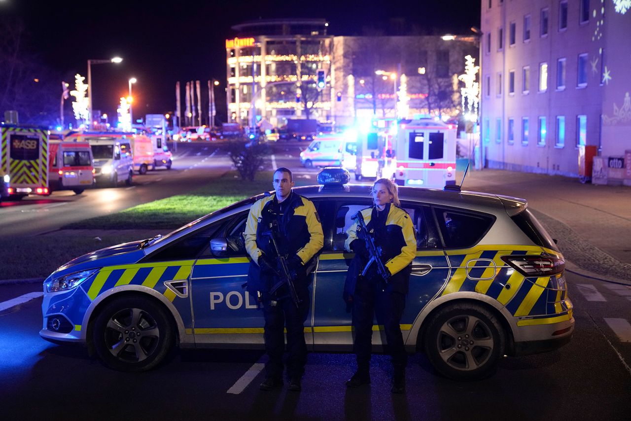 Police officers guard a cordoned off area near the scene where a car drove into a crowd at a Christmas market in Magdeburg on Friday, December 20.