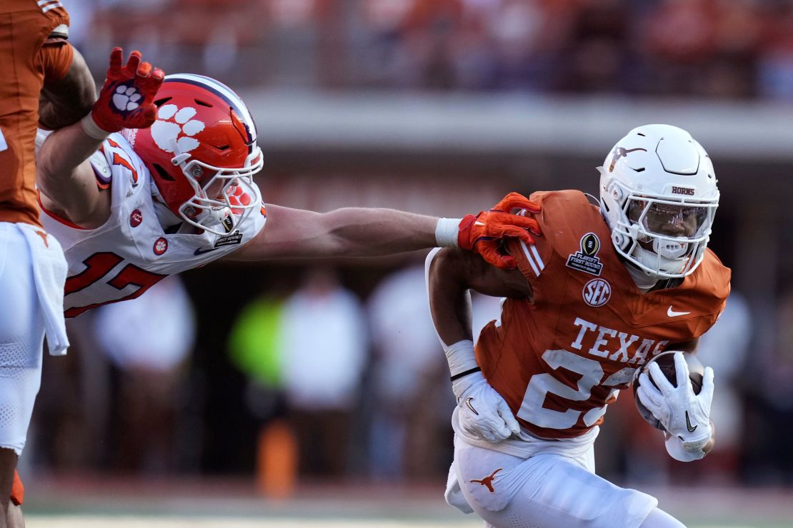 Texas running back Jaydon Blue runs form Clemson linebacker Wade Woodaz during the first half.