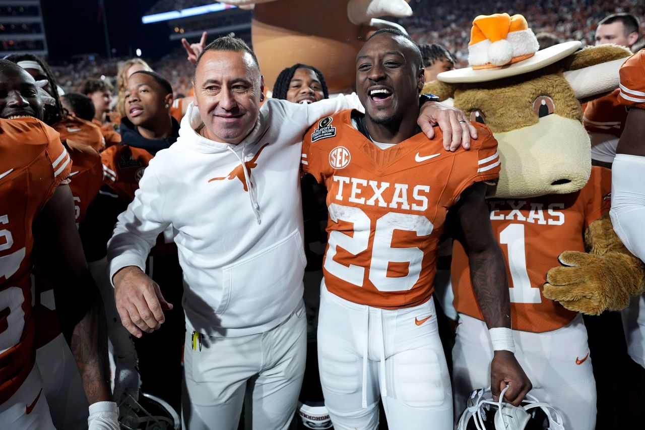 Texas head coach Steve Sarkisian celebrates with running back Quintrevion Wisner beating Clemson.