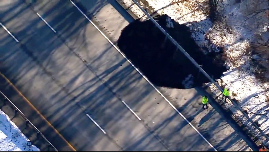 Work crews work near a sinkhole that opened up along Interstate 80 near Wharton, New Jersey, on December 26.