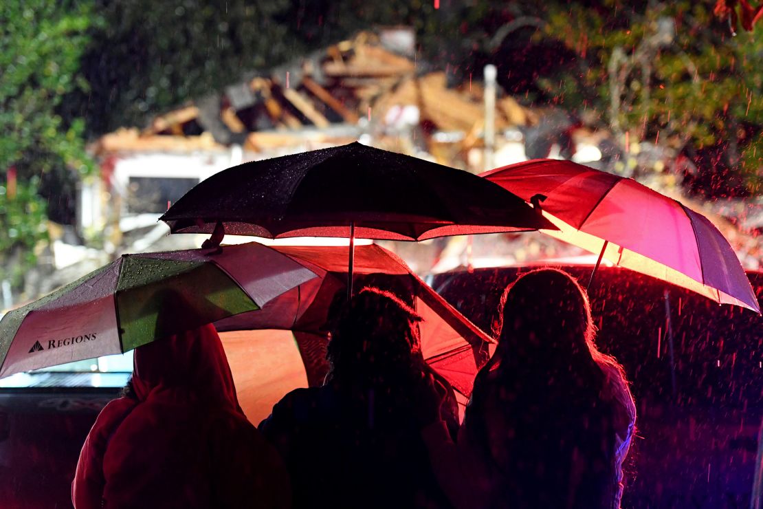 Bystanders watch as first responders work on December 28 in Natchez, Mississippi.