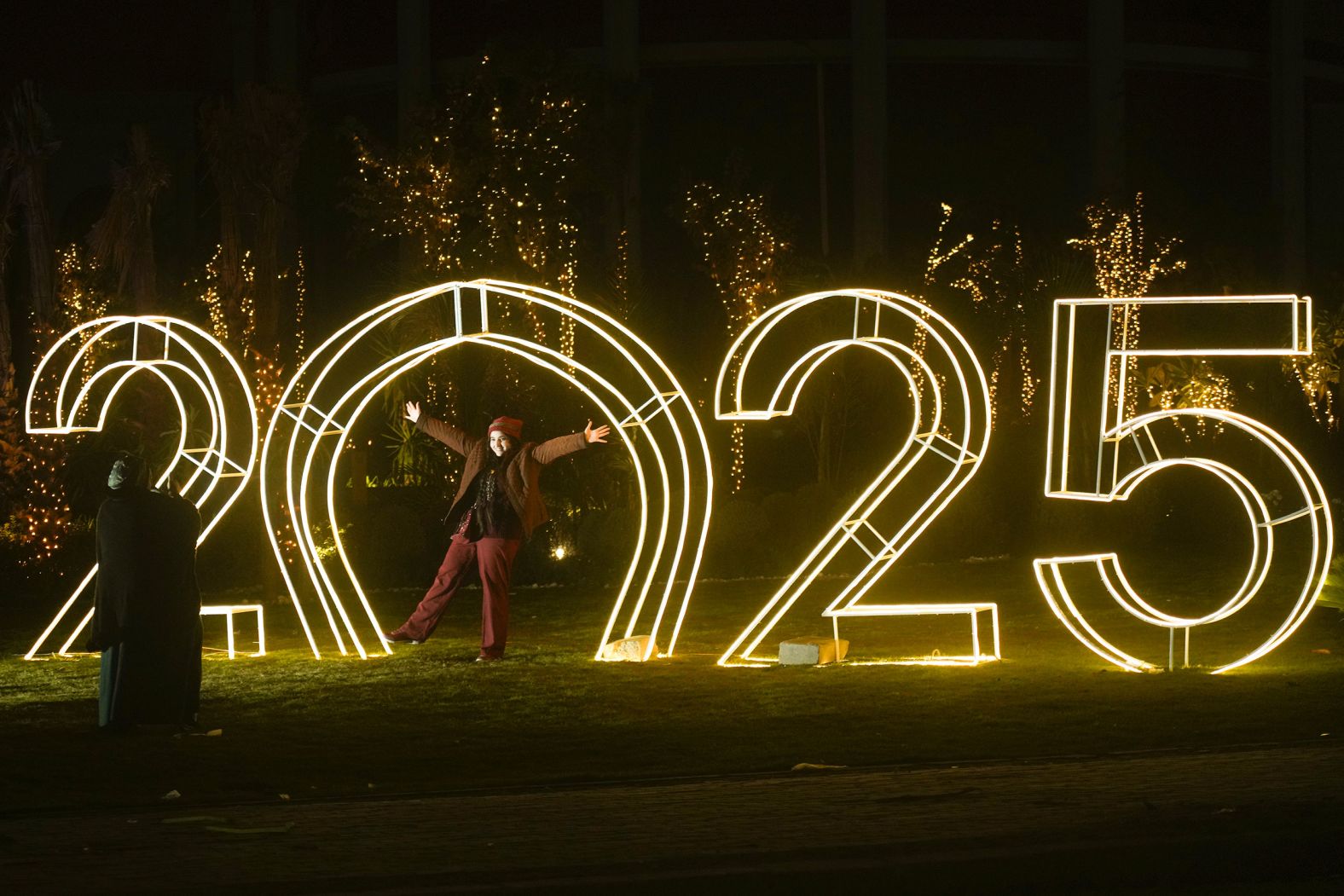 A person poses in front of a decoration in Cairo.