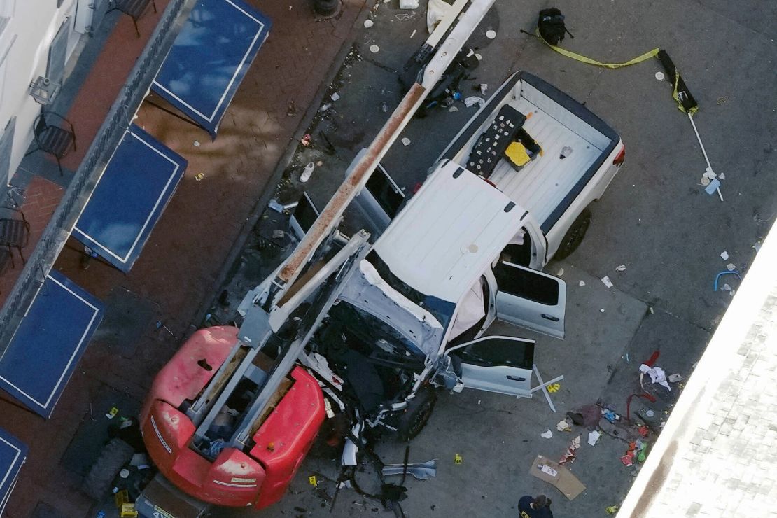 A black flag with white lettering lies rolled up on the ground behind the vehicle used in the New Orleans attack. The FBI said it recovered an ISIS flag, which is black with white lettering, from the pickup truck.