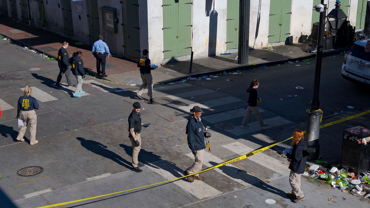 Members of the FBI walk around Bourbon Street during the investigation of a truck fatally crashing into pedestrians in New Orleans on Wednesday, January 1, 2025.
