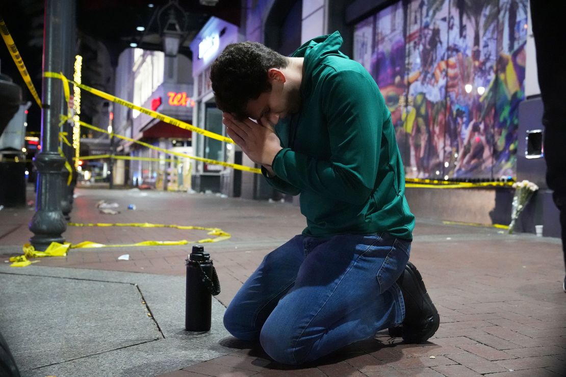 Matthias Hauswirth of New Orleans prays on the street near the scene of Wednesday's truck attack.