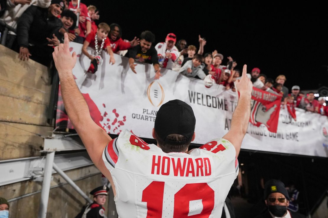 Ohio State quarterback Will Howard celebrates with fans after defeating Oregon.