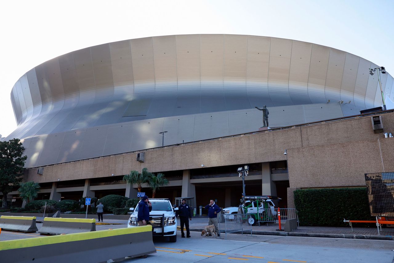 Security and bomb sniffing dogs check vehicles as they enter the Superdome parking garage ahead of the Sugar Bowl game on Thursday in New Orleans.