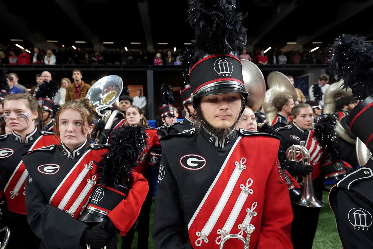 Georgia band members stand on the field during a moment of silence before the quarterfinals of a College Football Playoff against Notre Dame, Thursday, January 2, in New Orleans.