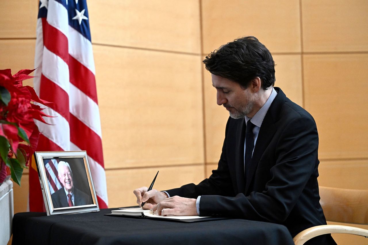 Canadian Prime Minister Justin Trudeau signs a book of condolences for former US President Jimmy Carter at the US Embassy in Ottawa, on January 3.