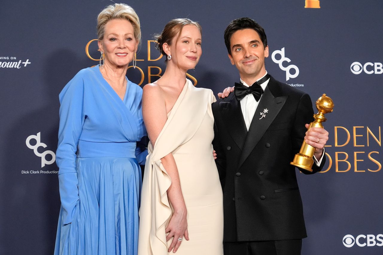 Jean Smart, Hannah Einbinder, and Paul W. Downs pose with their award in the Golden Globes press room.