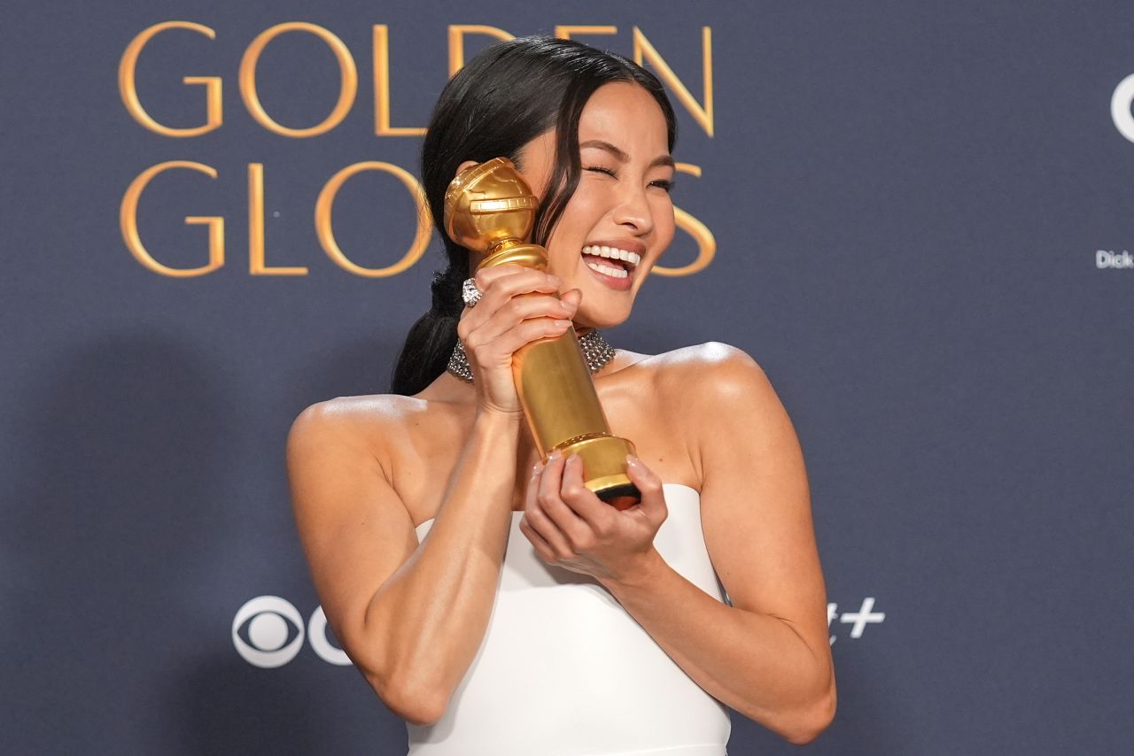 Anna Sawai poses with her Golden Globe award for best female actor in a drama series.