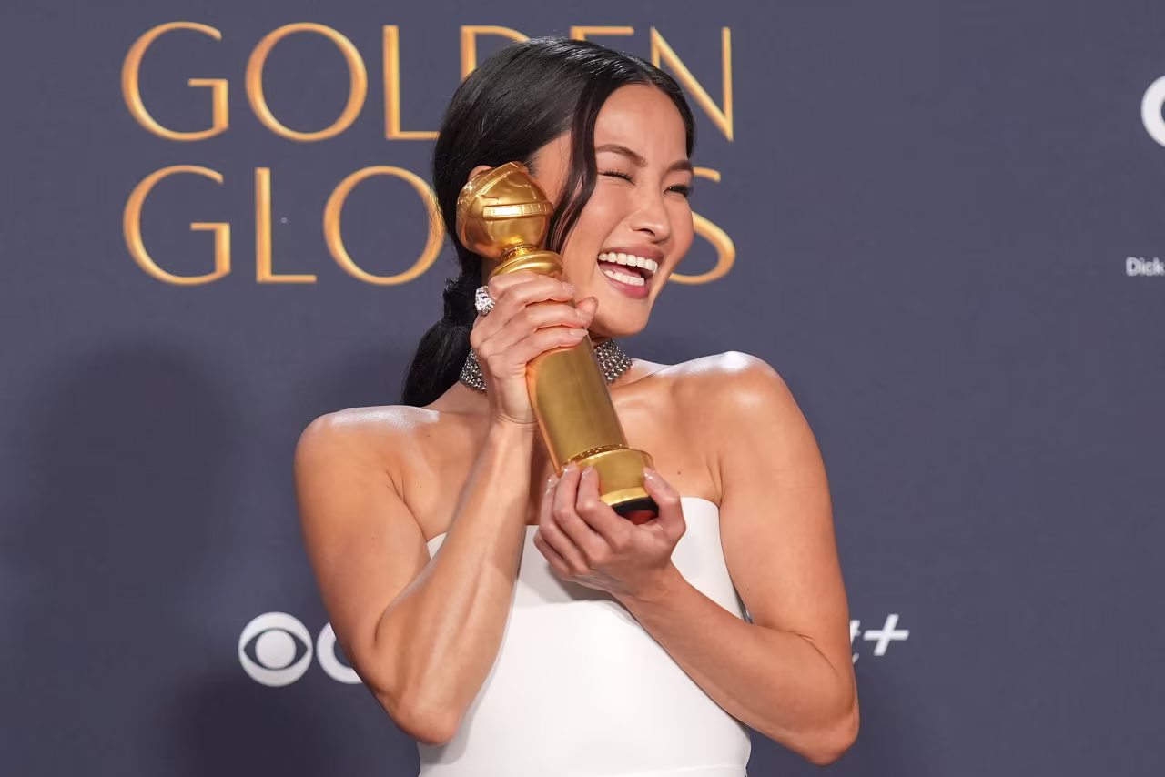 Anna Sawai poses with her Golden Globe award for best female actor in a drama series.