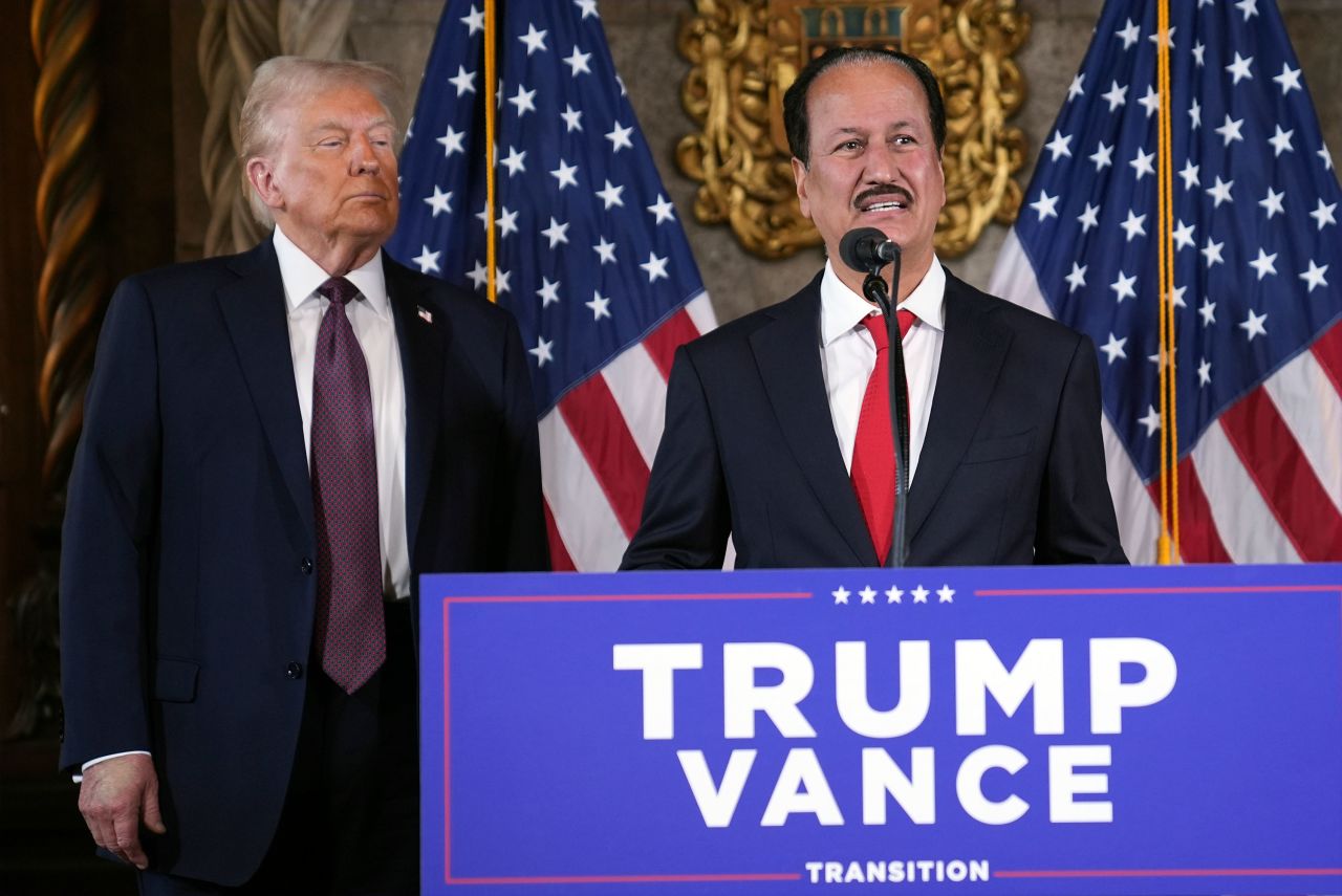 President-elect Donald Trump listens to a speech by Damac Properties CEO Hussein Sajwani during a press conference at Mar-a-Lago on Tuesday.