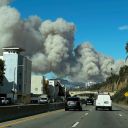 Heavy smoke from a brush fire in the Pacific Palisades rises over the Pacific Coast Highway in Santa Monica, Calif., on Tuesday, Jan. 7, 2025. (AP Photo/Eugene Garcia)