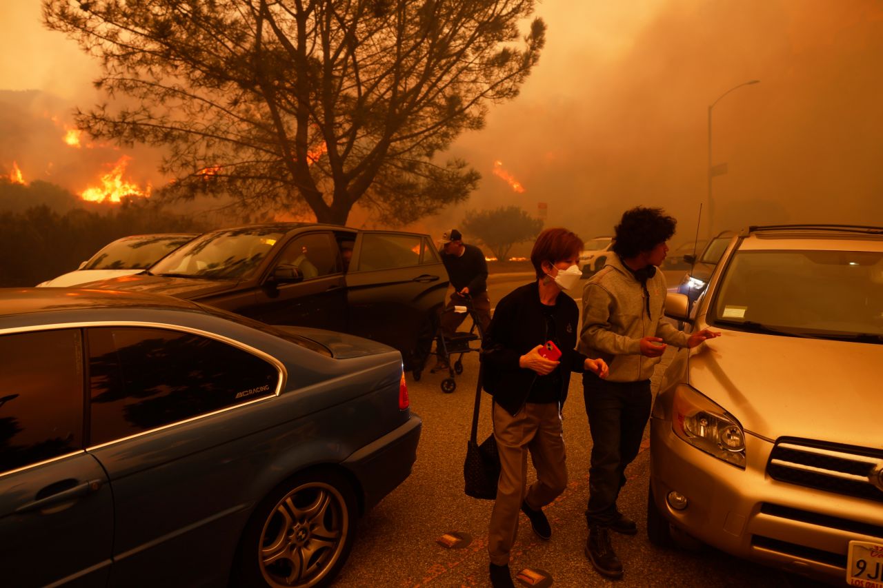 People flee from the fire in the Pacific Palisades neighborhood of Los Angeles.