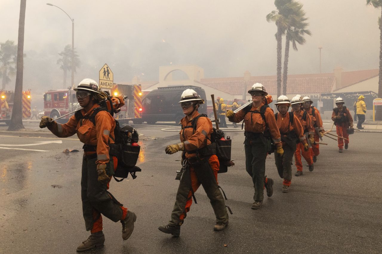 Firefighters work to fight the fire in Pacific Palisades, Los Angeles, California.