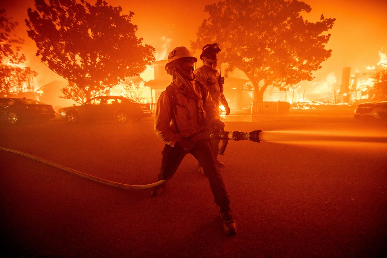 Firefighters battle the Palisades Fire as it burns multiple structures in the Pacific Palisades neighborhood of Los Angeles, on January 7.