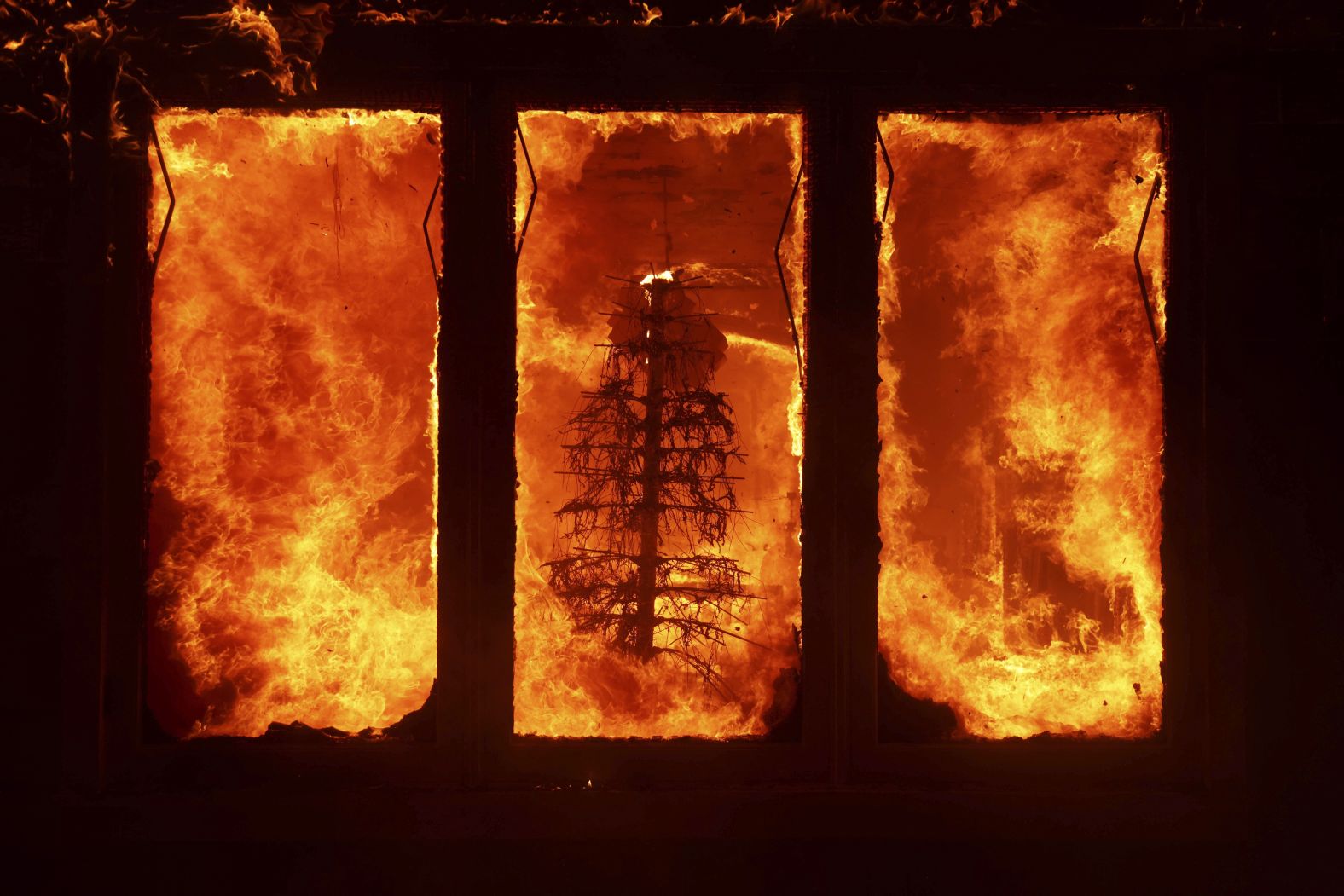 The Palisades Fire burns a Christmas tree inside a home.