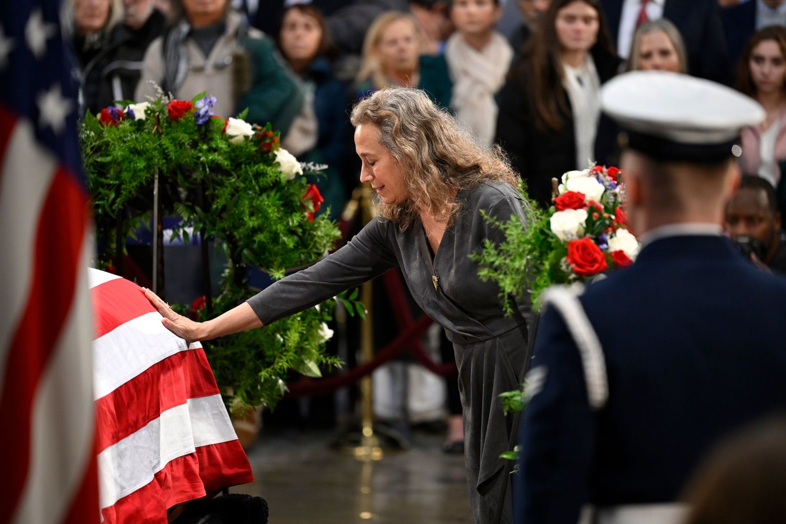 A person touches Carter's casket as he lies in state on January 8.