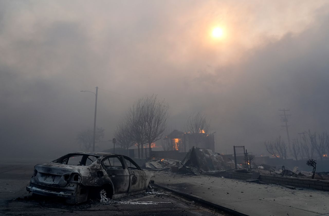 A burned-out car sits among rubble in the downtown Altadena section of Pasadena, California, on January 8.