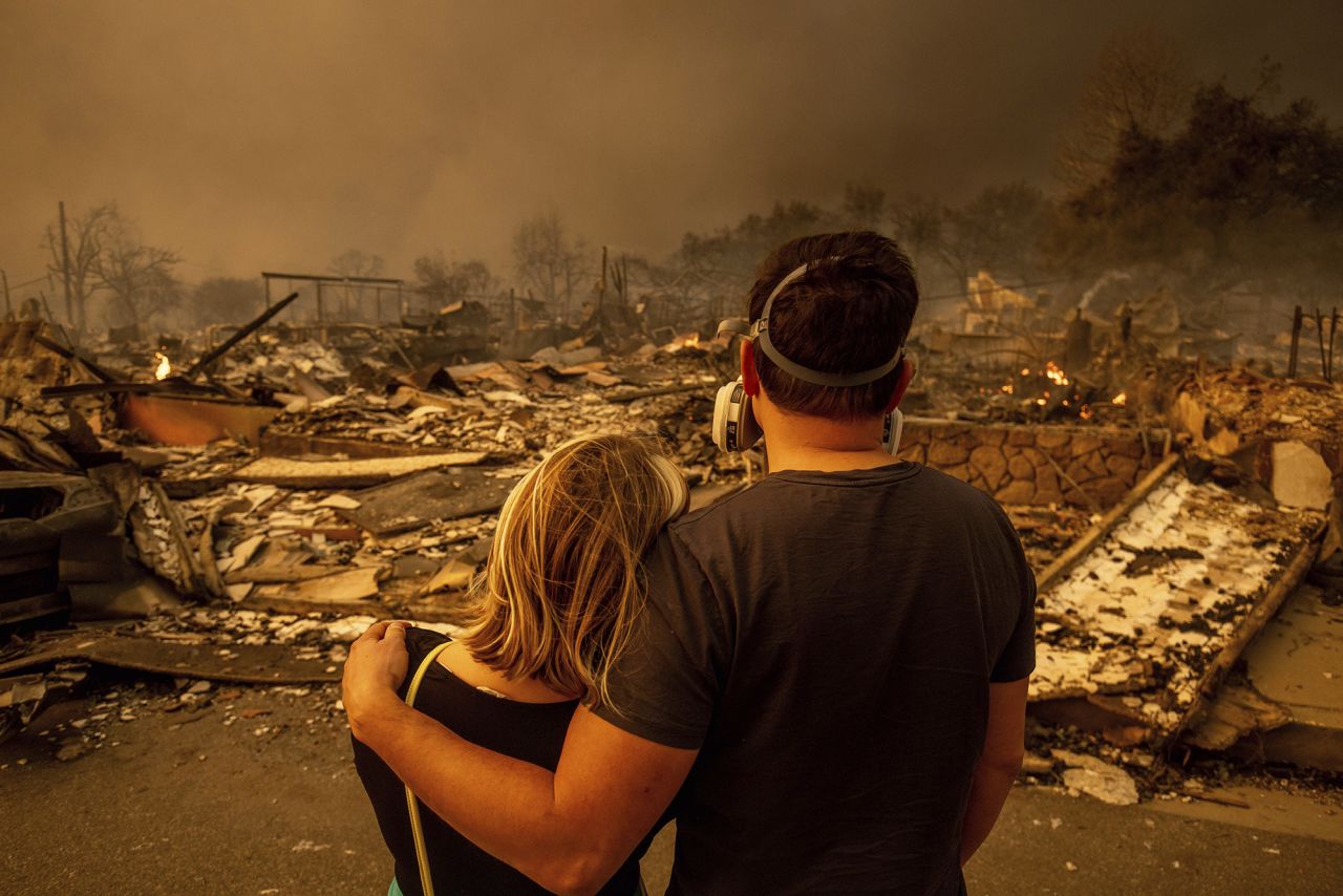 Megan Mantia, left, and her boyfriend Thomas, return to Mantia's fire-damaged home after the Eaton fire swept through the area, on January 8.