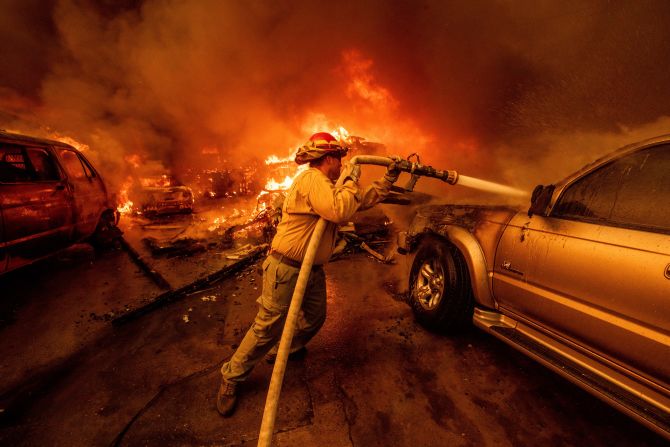 A firefighter battles the Eaton Fire in Altadena.