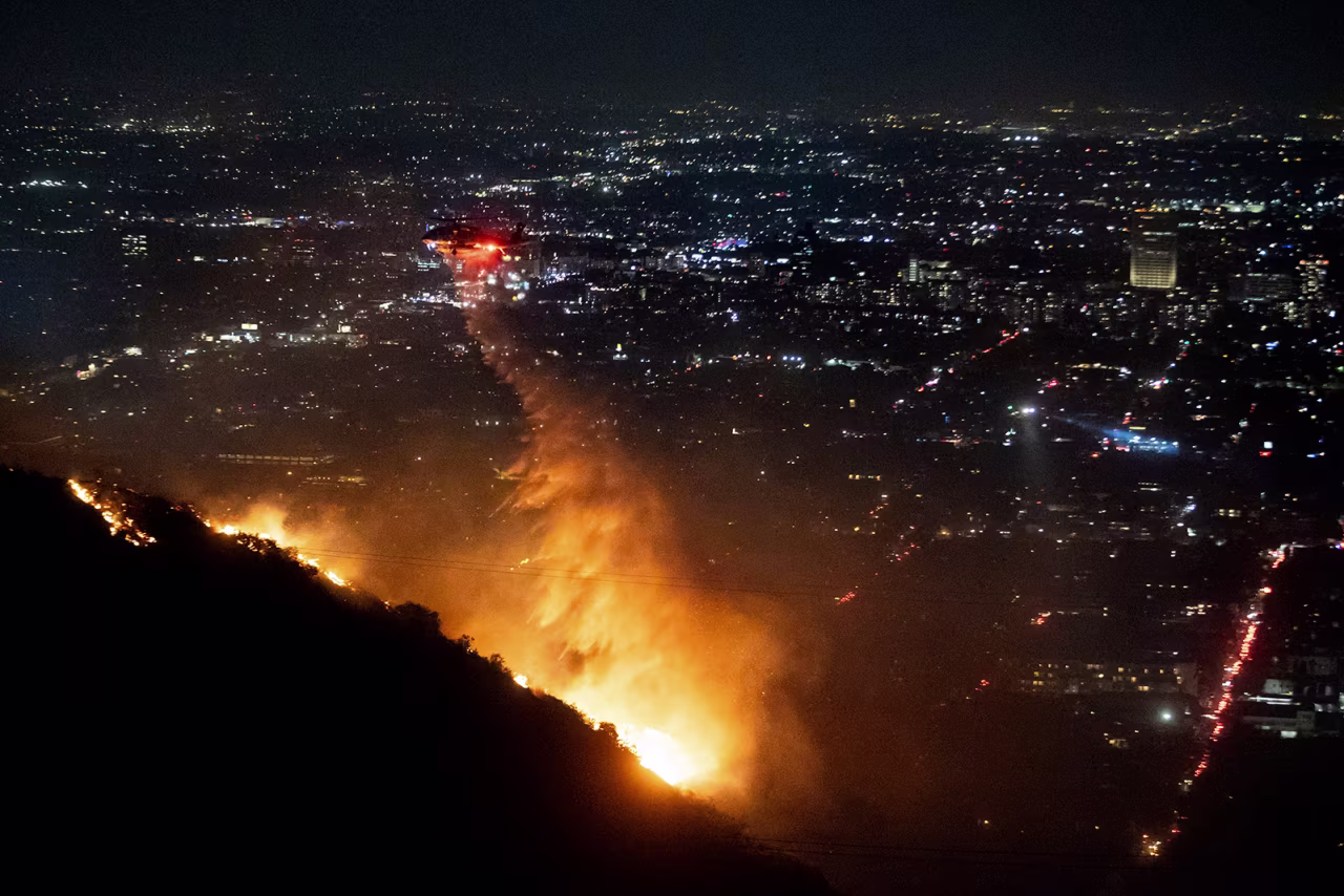 Water is dropped by helicopter on the burning Sunset Fire in the Hollywood Hills section of Los Angeles on January 8.