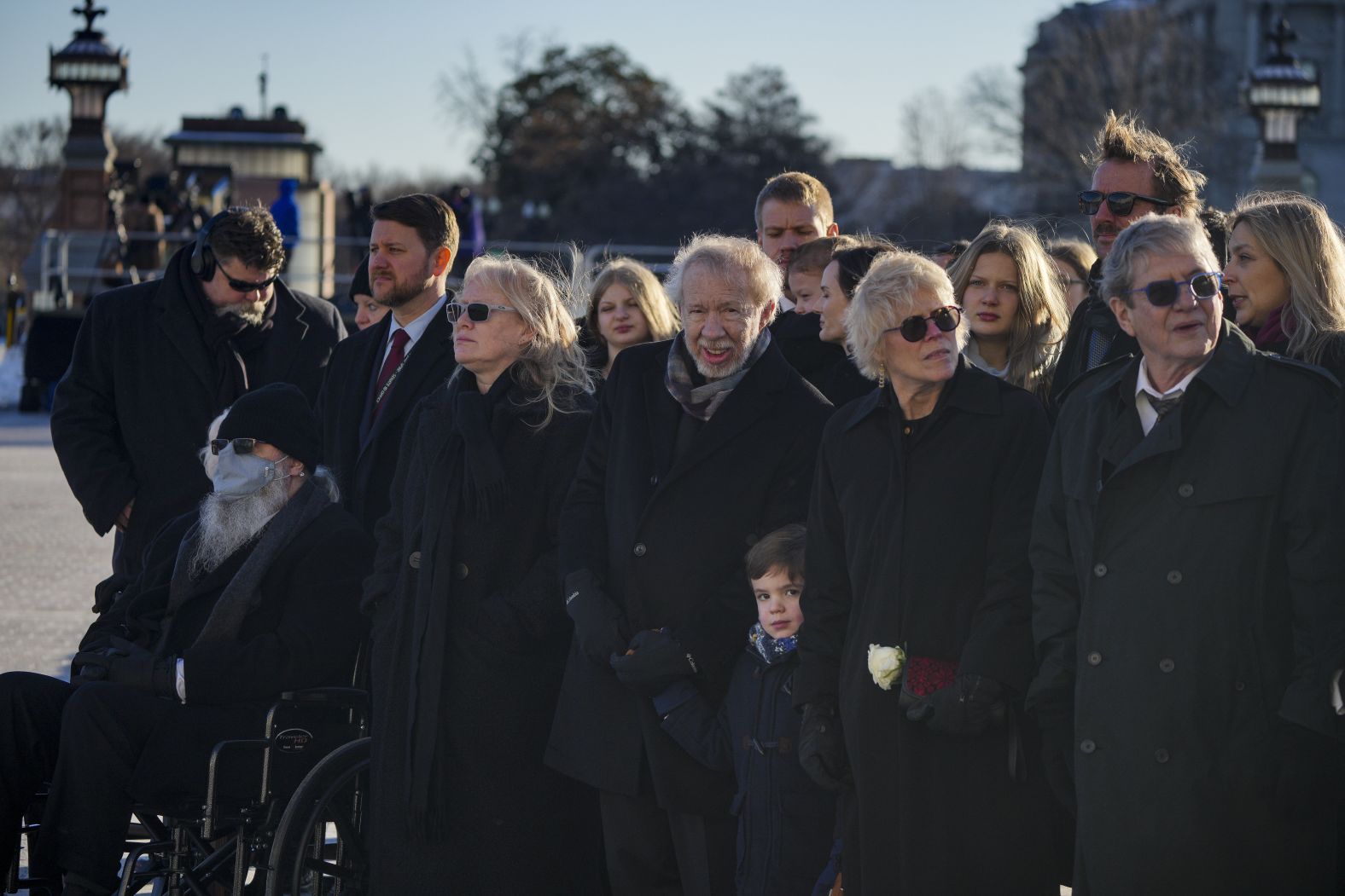 Carter's children and other members of his family watch as his casket is taken away from the US Capitol before heading to the cathedral.