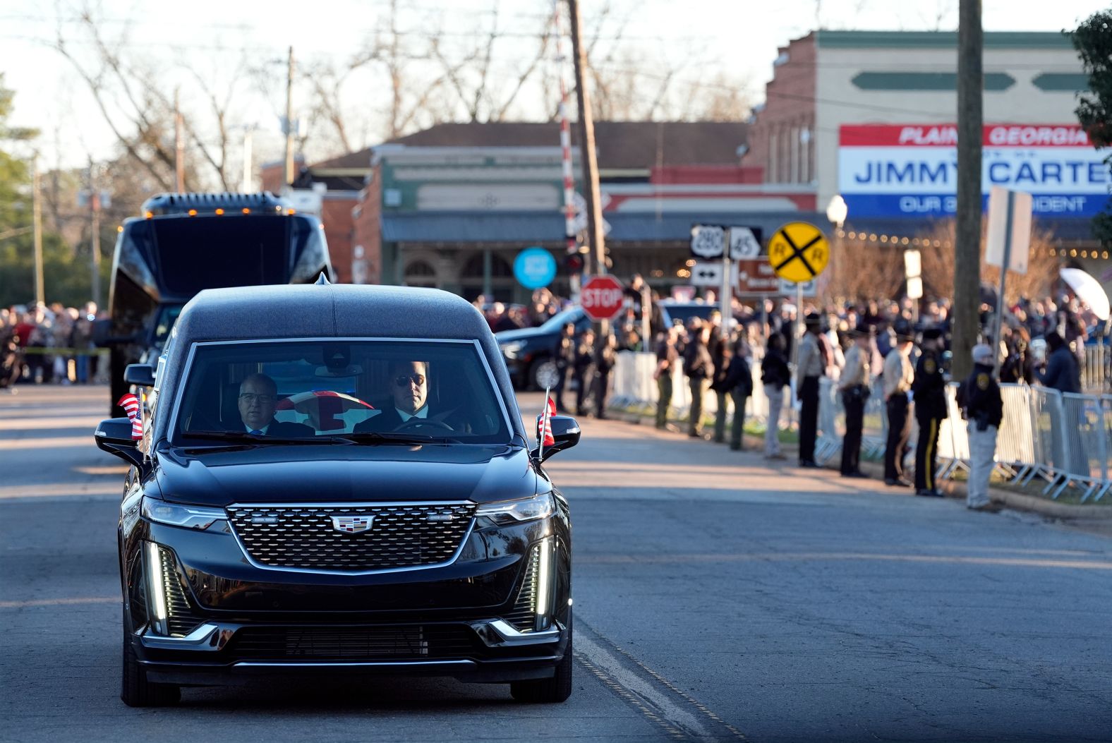 The hearse drives toward Maranatha Baptist Church.