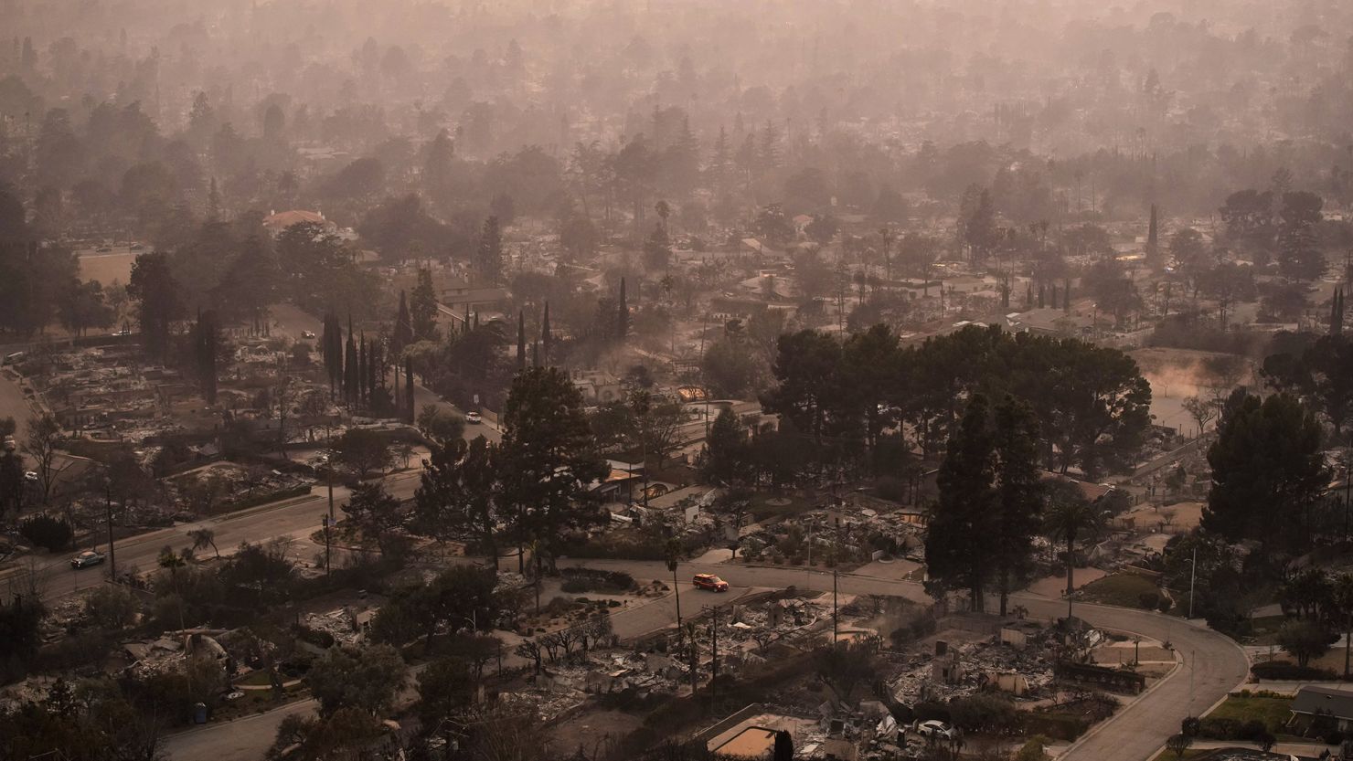 Smoke lingers over a neighborhood devastated by the Eaton Fire, Thursday, January 9, in Altadena, California.